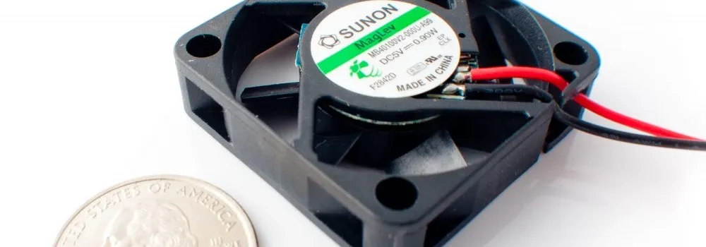 A small SUNON MagLev DC cooling fan shown next to a US quarter for scale.